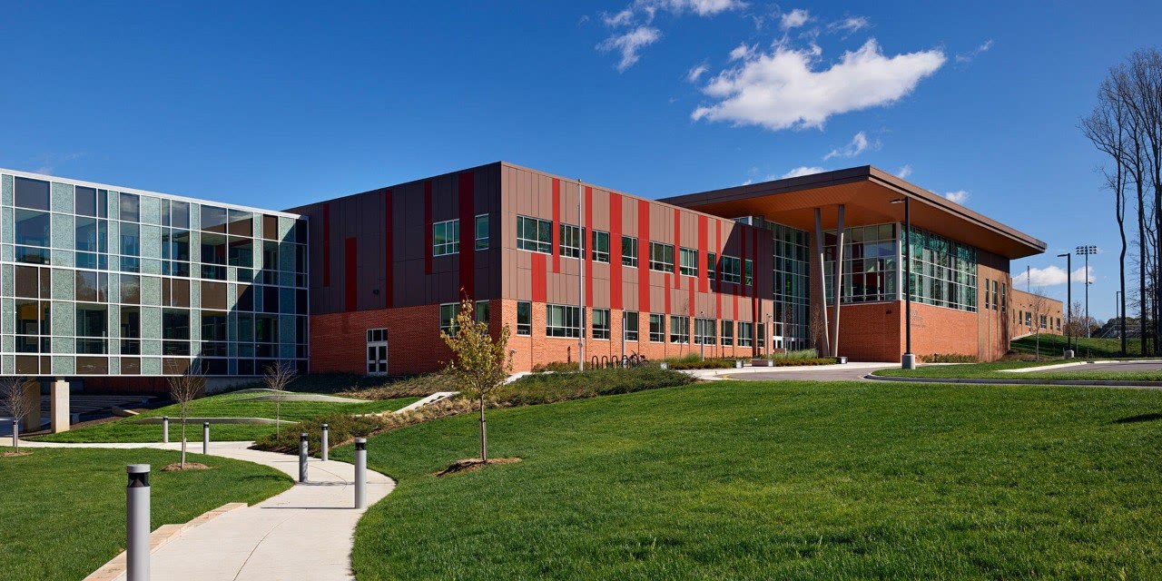 Exterior of Crofton High School with its modern red, brick, and glass facade
