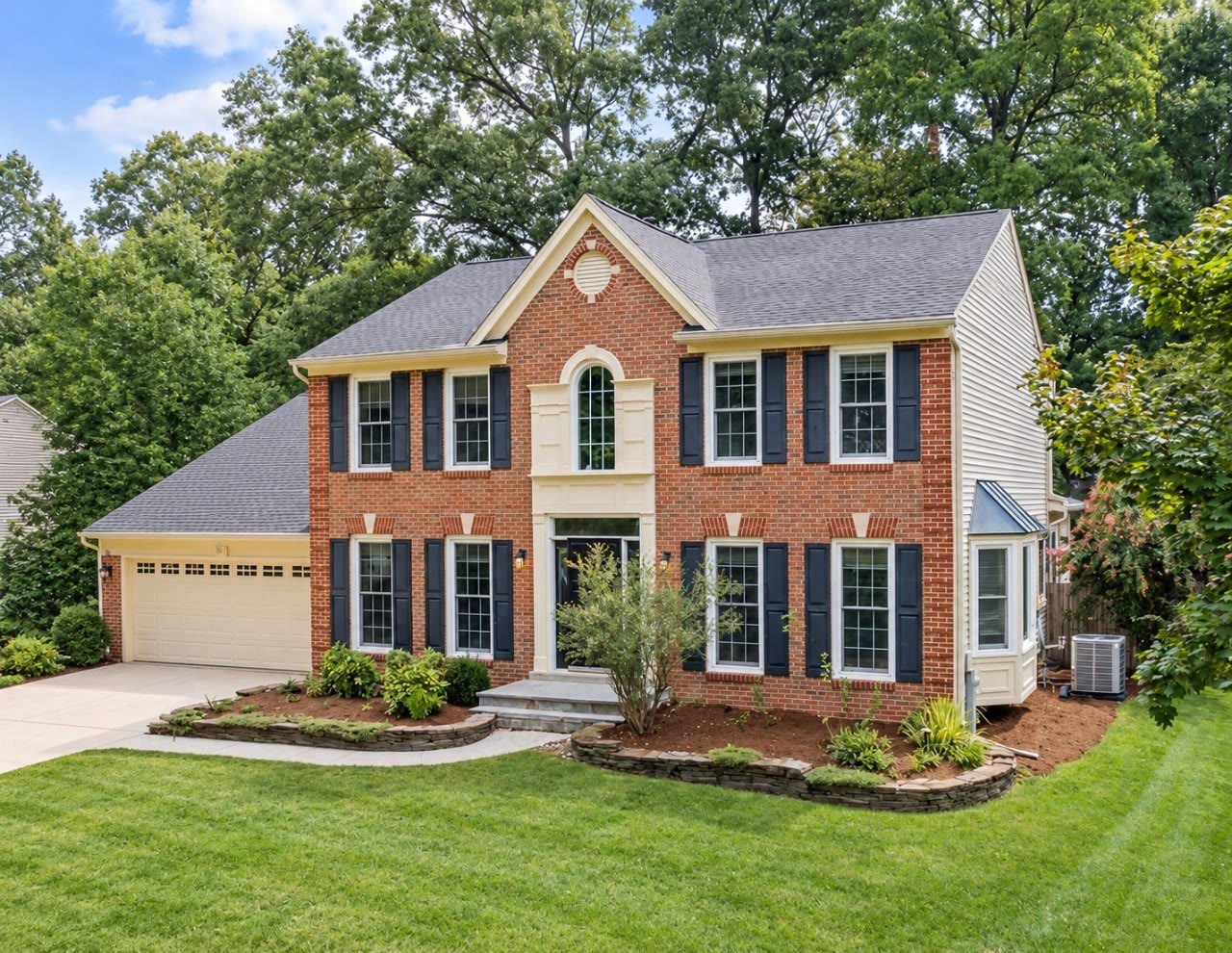 Landscaped two-story brick colonial home in Crofton