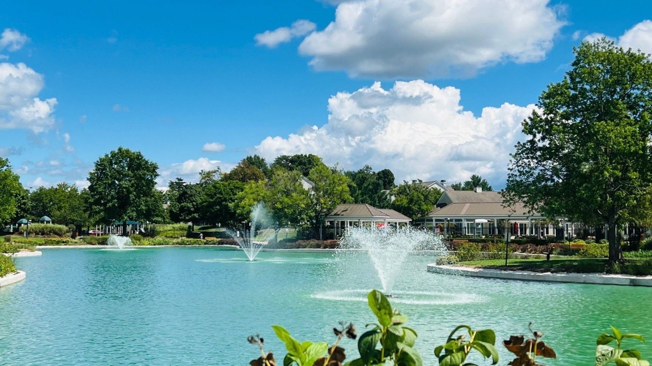 Landscaped community pond with fountains in Odenton